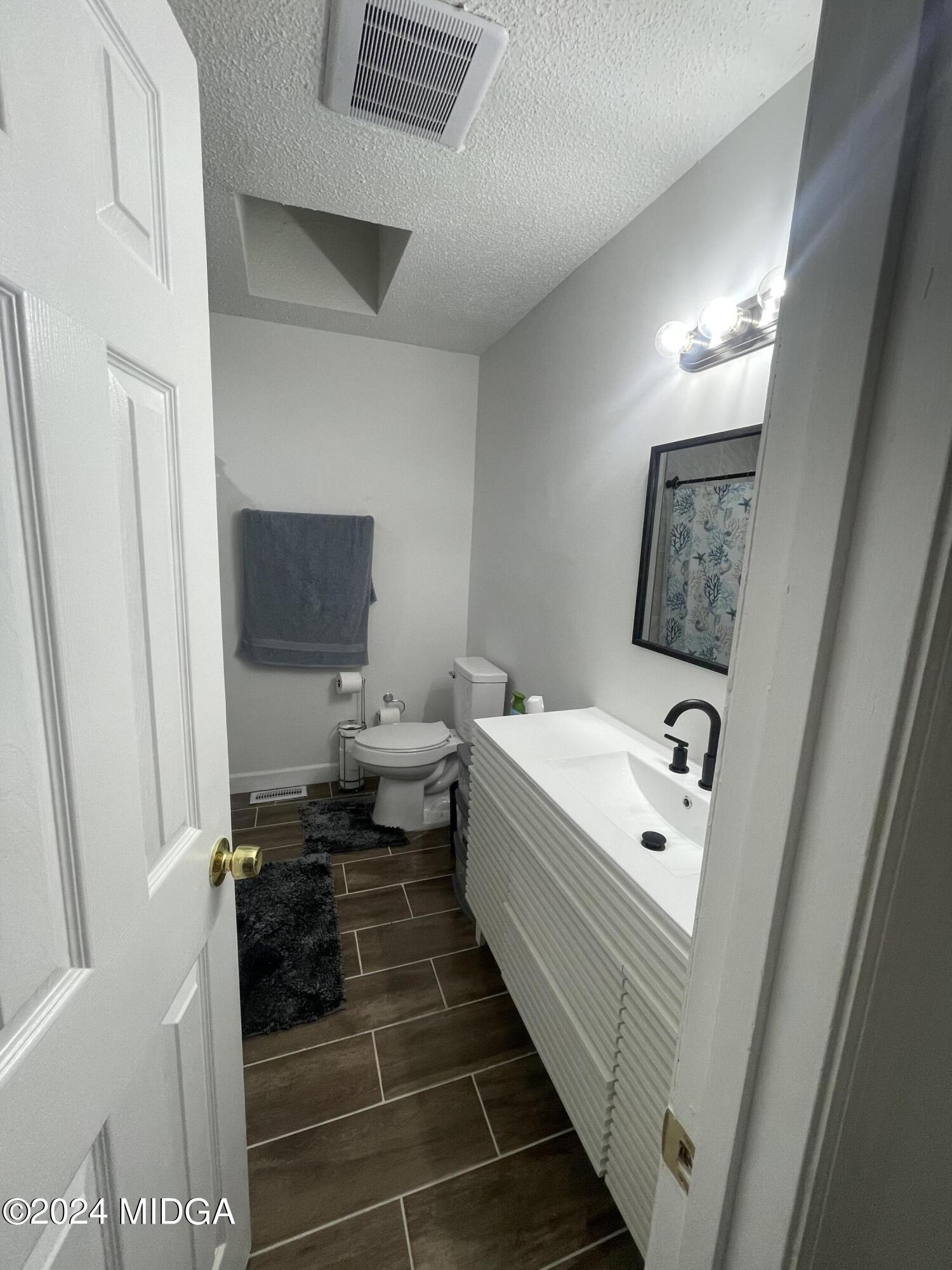 4064 Emory Drive Macon, GA 31206 - Photo 26 of 37 a bathroom with a sink and mirror