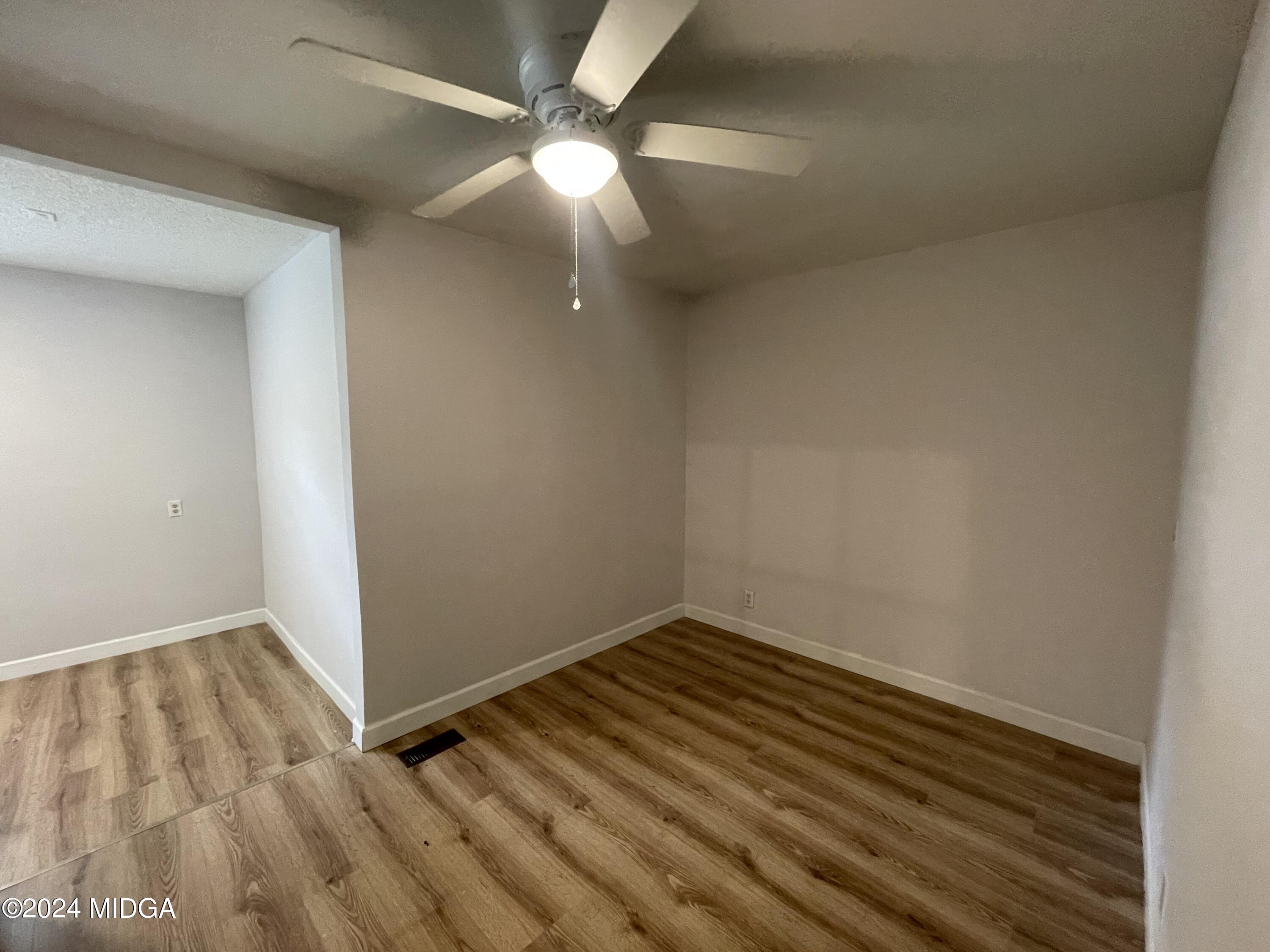 4064 Emory Drive Macon, GA 31206 - Photo 30 of 37 an empty room with wooden floor fan and window