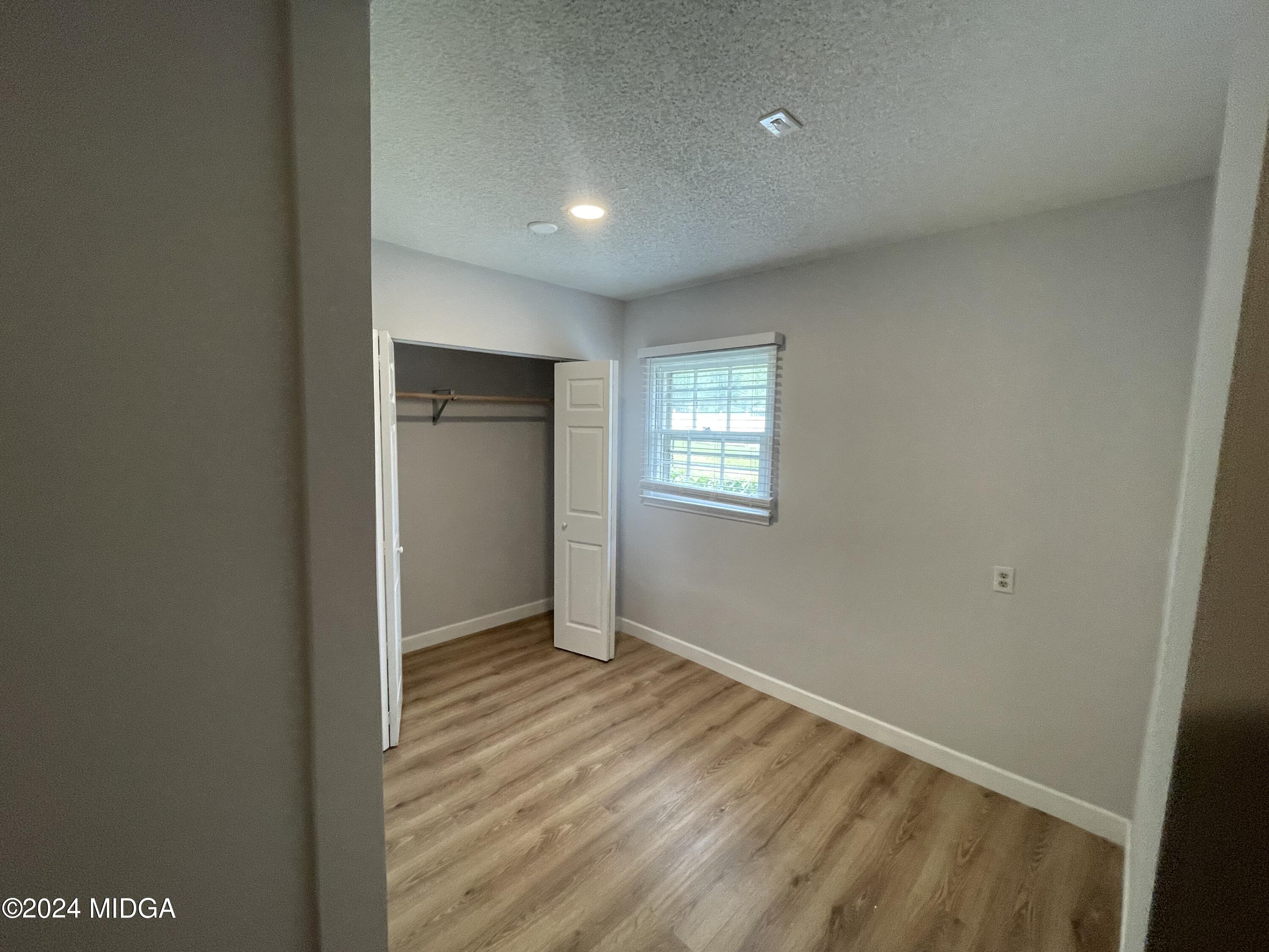 4064 Emory Drive Macon, GA 31206 - Photo 32 of 37 a view of an empty room with wooden floor and a window