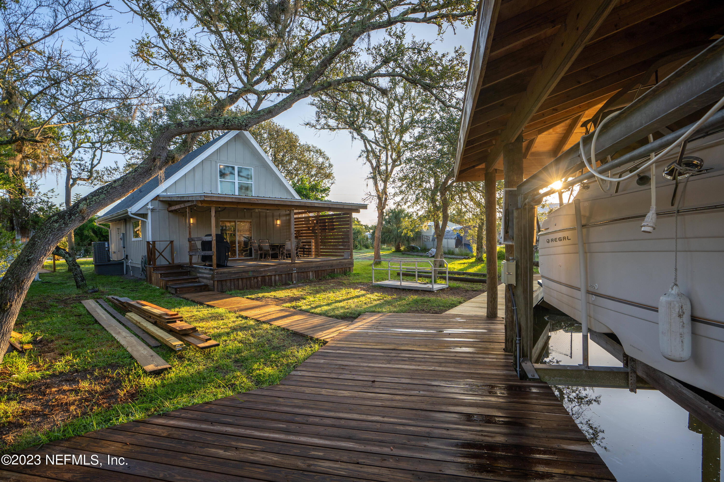281 Ole Road St. Augustine, FL 32080 - Photo 28 of 61 a view of swimming pool with lounge chair and dinning table under an umbrella