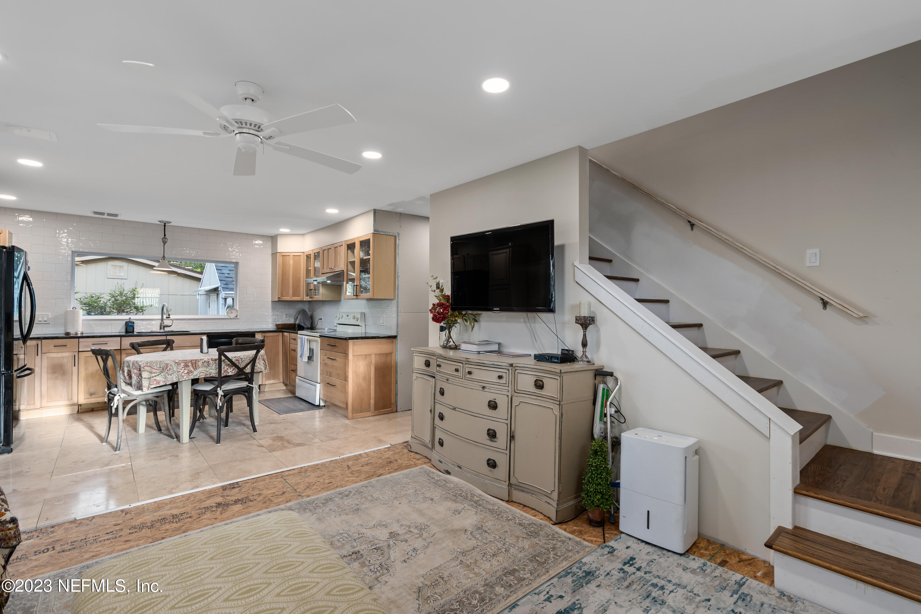 281 Ole Road St. Augustine, FL 32080 - Photo 35 of 61 a kitchen with stainless steel appliances kitchen island granite countertop a stove top oven a sink a dining table and chairs with wooden floor