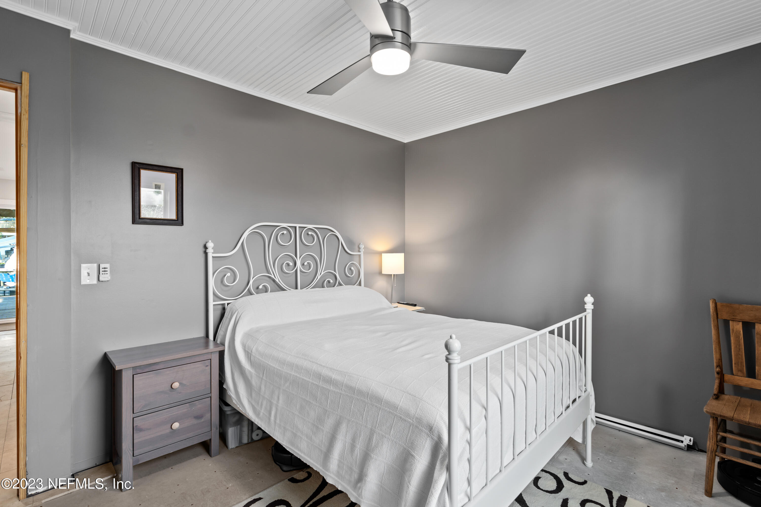 281 Ole Road St. Augustine, FL 32080 - Photo 43 of 61 a bedroom with a bed and a chandelier