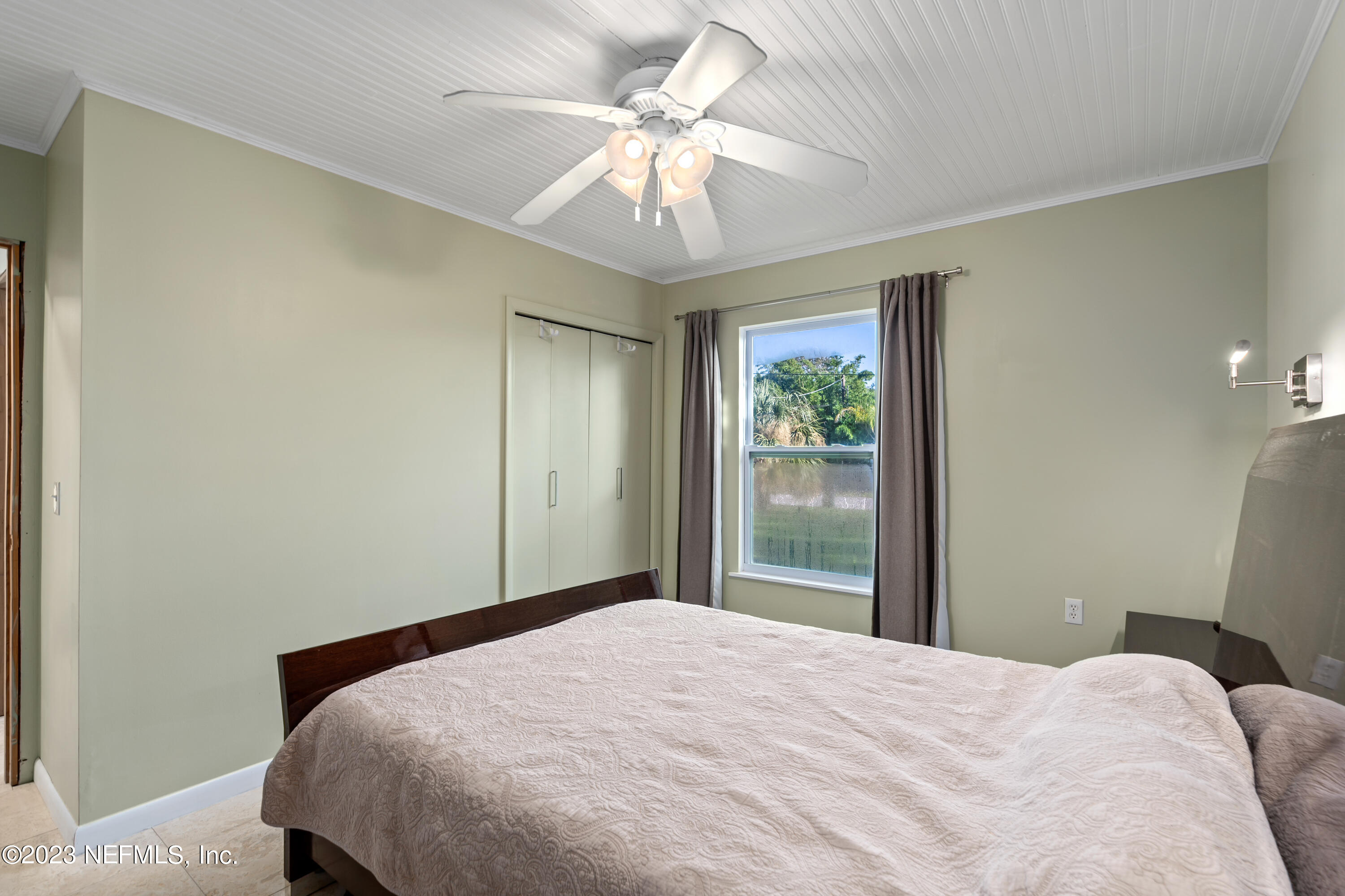 281 Ole Road St. Augustine, FL 32080 - Photo 47 of 61 a bedroom with a bed and a chandelier