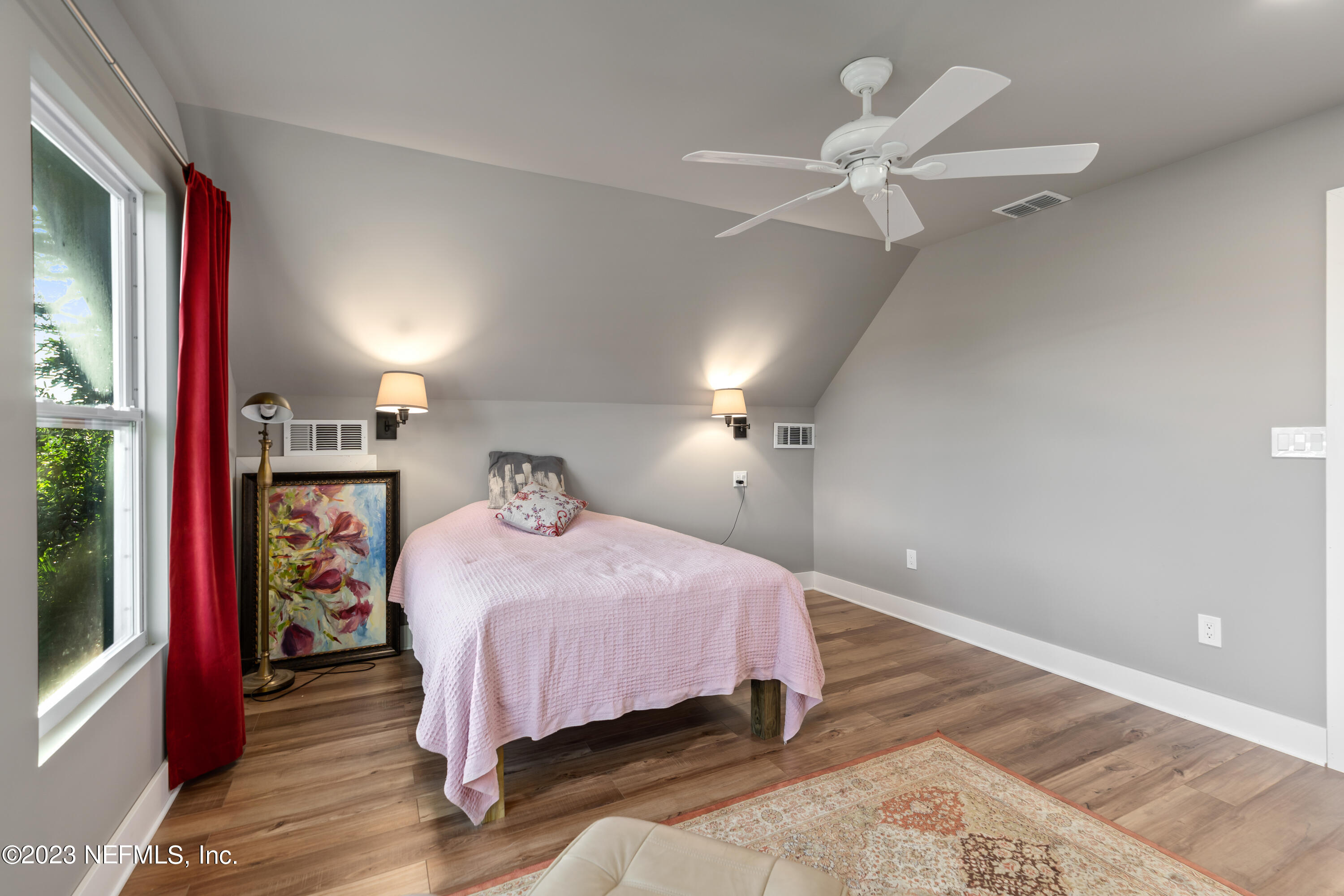 281 Ole Road St. Augustine, FL 32080 - Photo 55 of 61 a bedroom with a bed and a chandelier