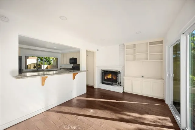 a view of living room with a fireplace and wooden floor