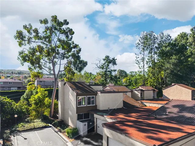 a wooden bench sitting in backside of a house