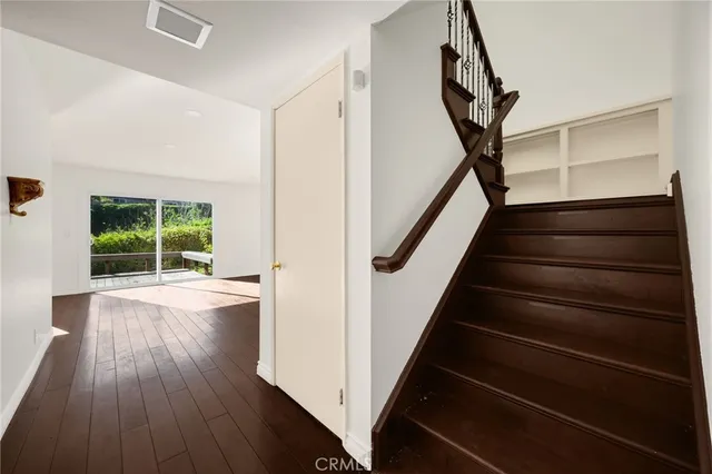a view of entryway with wooden floor and stairs