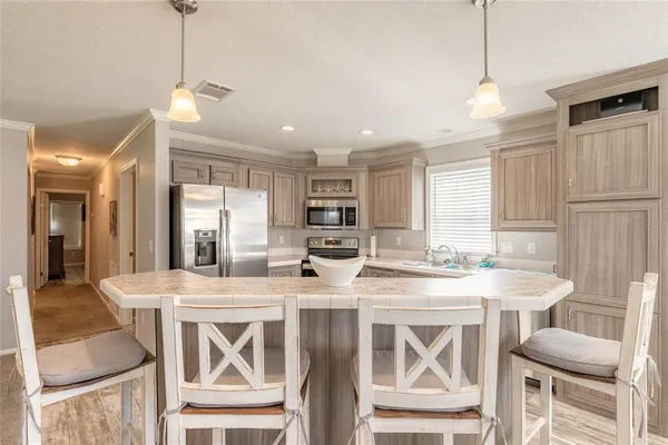 a large kitchen with a table and chairs
