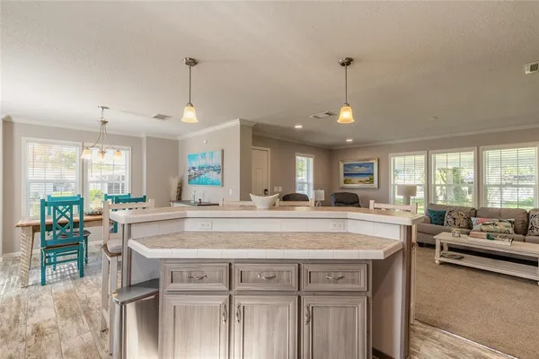 a view of a kitchen center island and living room