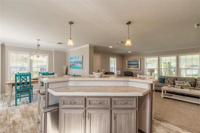 a view of a kitchen center island and living room
