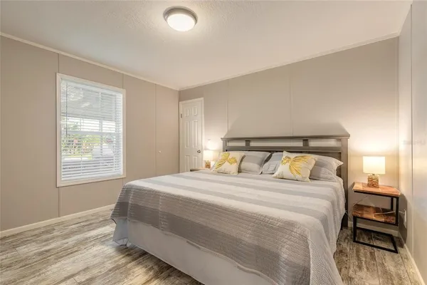 a bedroom with a bed and a window