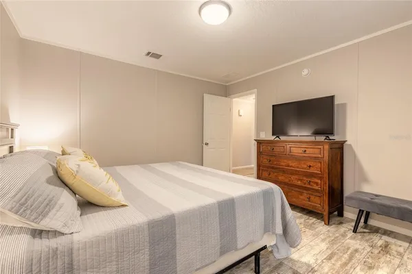 a bedroom with a bed and a flat screen tv