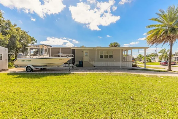 a swimming pool with outdoor seating and yard