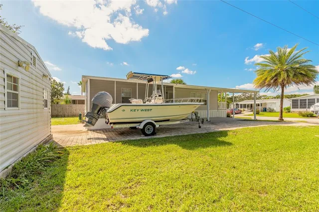 a view of a swimming pool with a lawn chairs under an umbrella