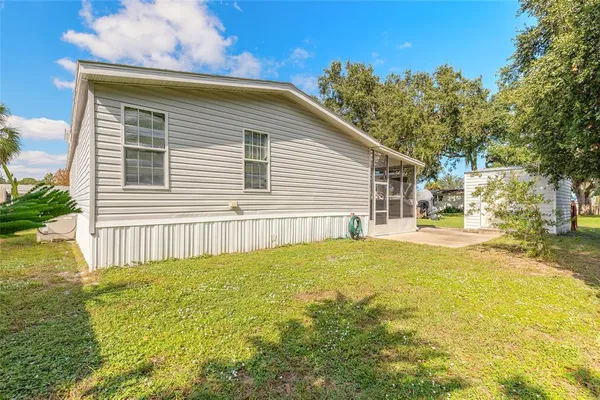 a view of a house with a yard and sitting area