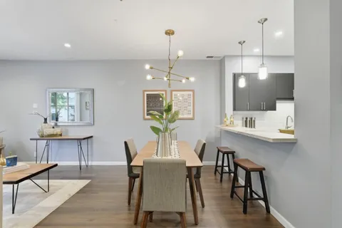 a view of a dining room with furniture window and wooden floor