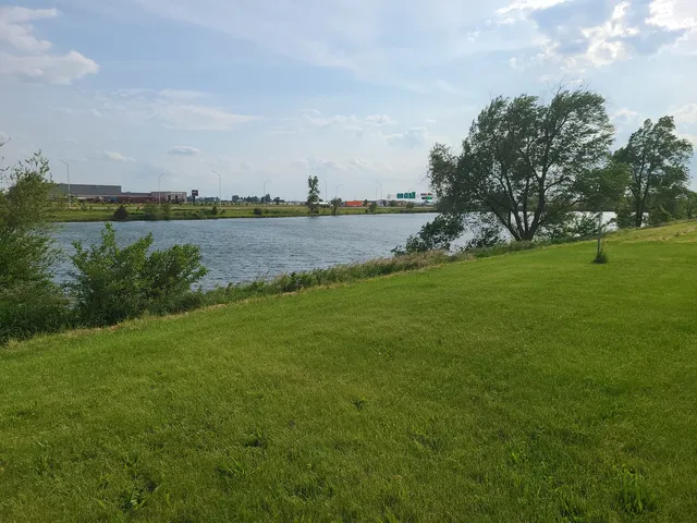 a view of a lake with houses in the back