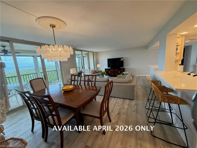 a view of a dining room with furniture and a chandelier