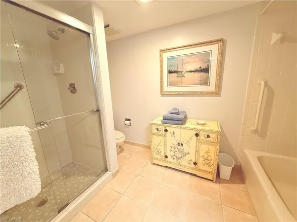 a spacious bathroom with a tub shower and sink