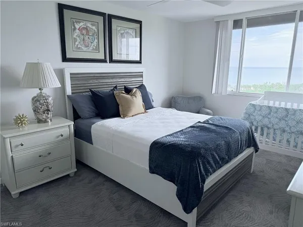 a spacious bedroom with a bed and window