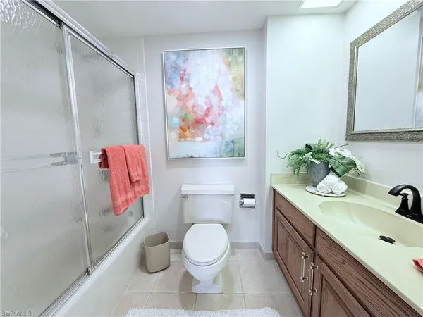 a bathroom with a sink a toilet and a shower