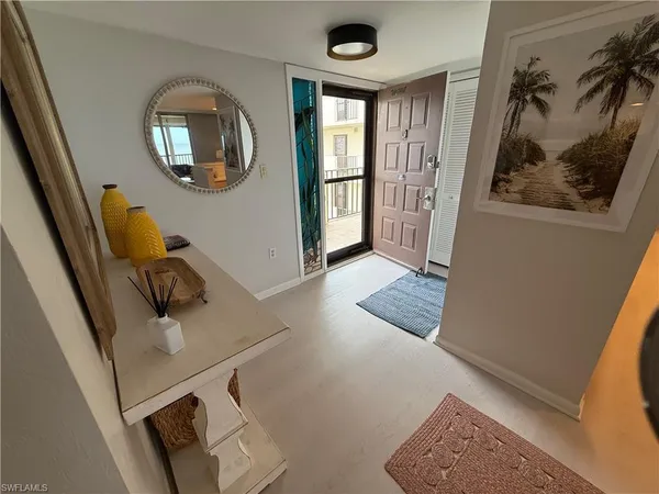 a view of a livingroom with furniture and mirror