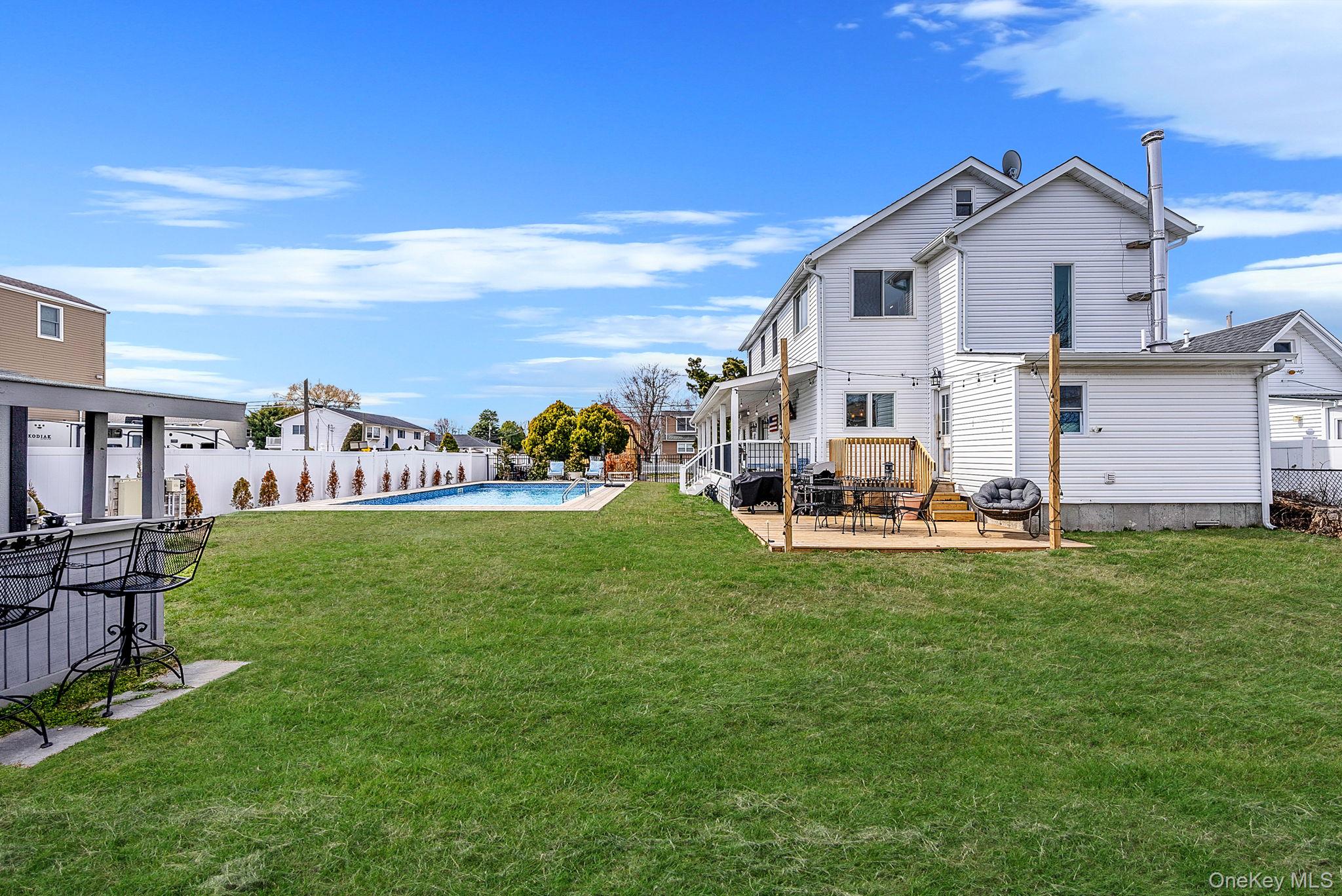 794 Pecan Street Lindenhurst, NY 11757 - Photo 11 of 44 a view of a house with a yard porch and sitting area