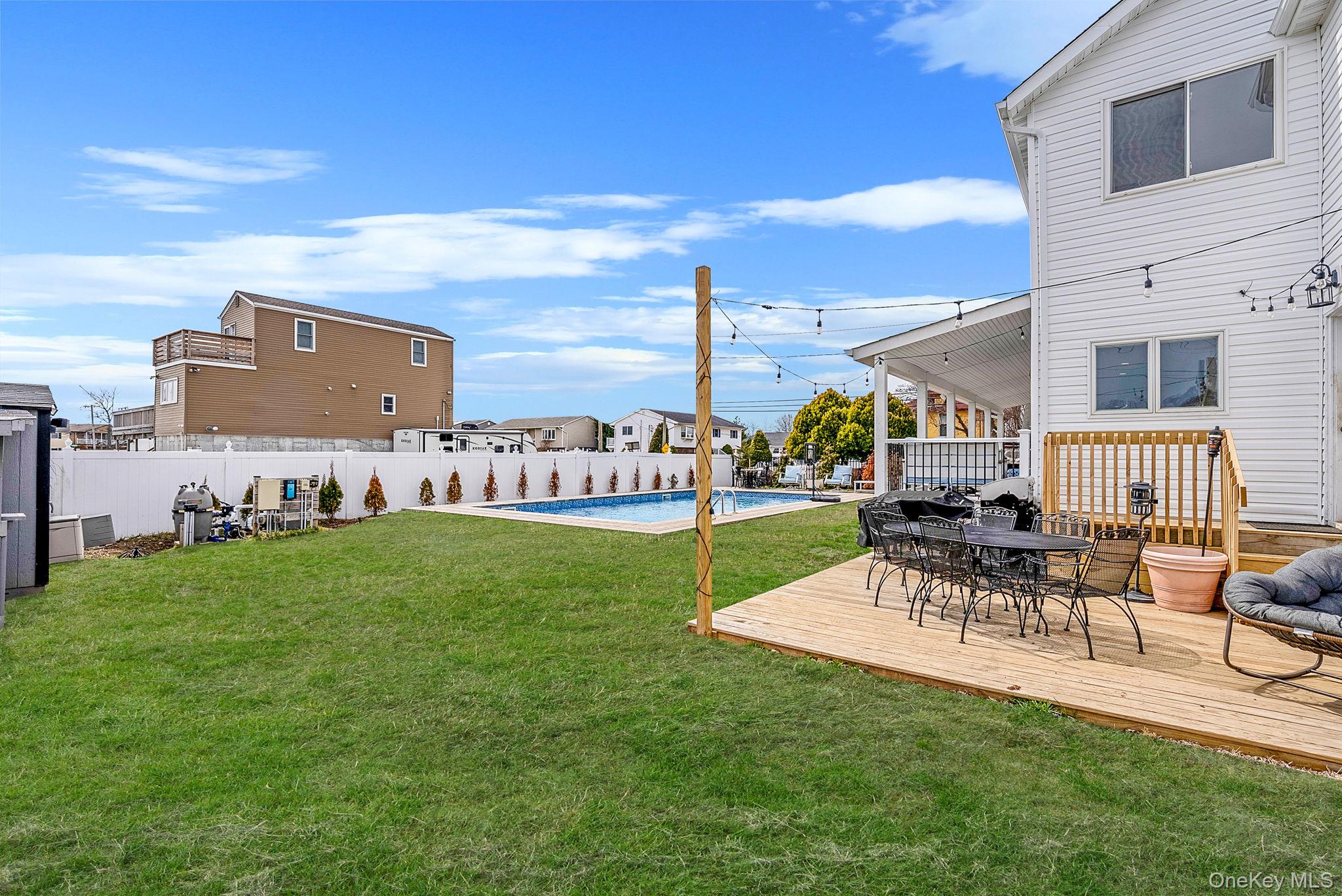 794 Pecan Street Lindenhurst, NY 11757 - Photo 12 of 44 a view of a chairs and table in patio