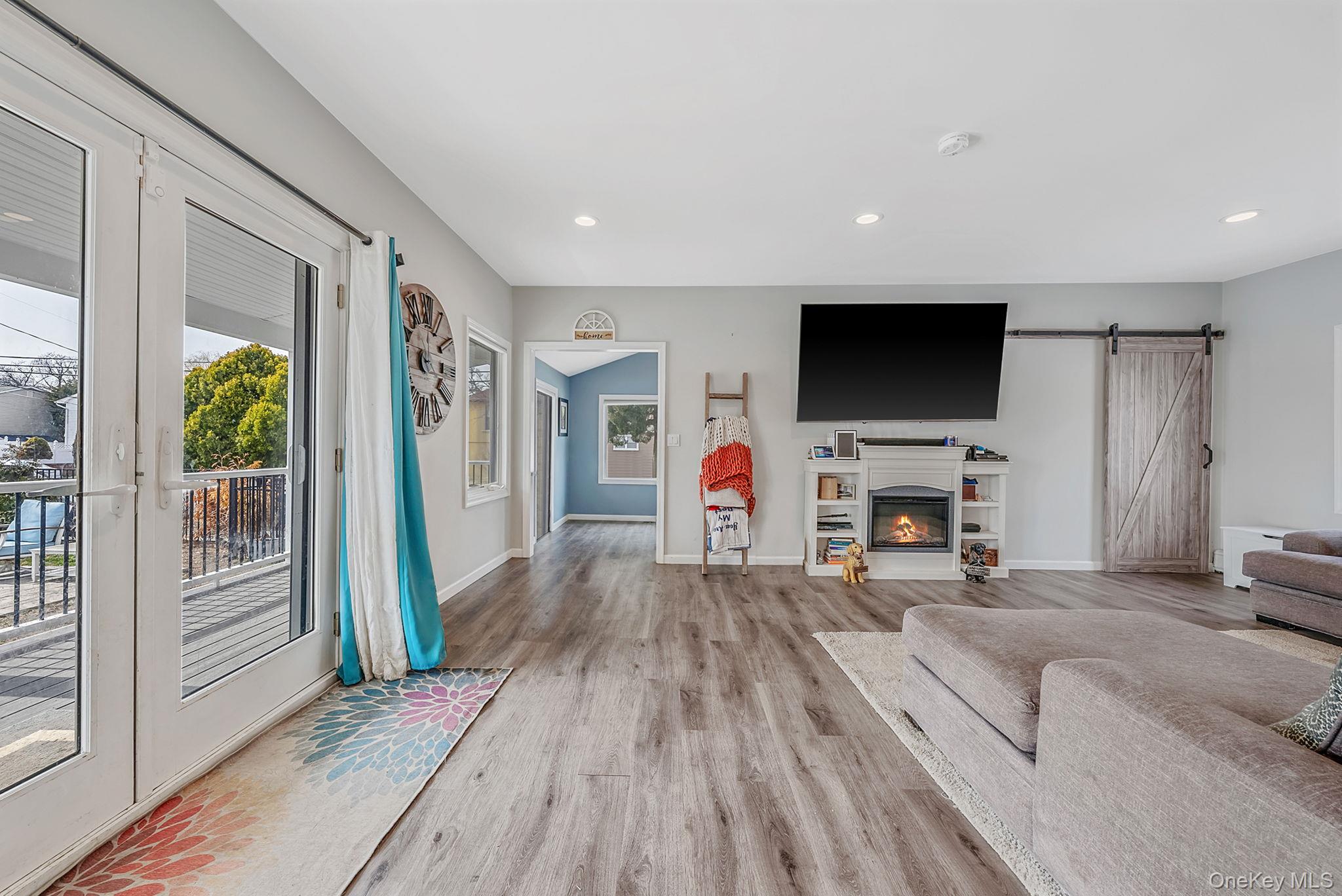794 Pecan Street Lindenhurst, NY 11757 - Photo 19 of 44 a living room with furniture and a flat screen tv