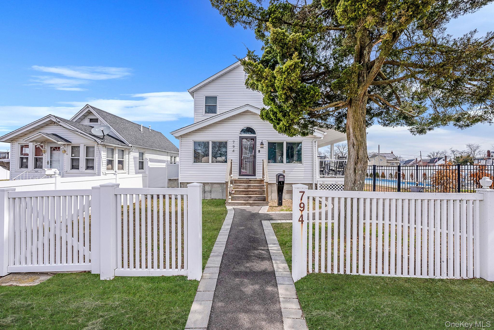 794 Pecan Street Lindenhurst, NY 11757 - Photo 2 of 44 a front view of a house with a garden