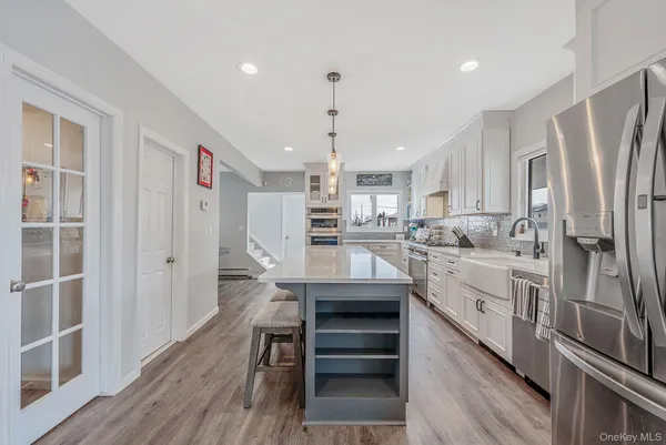 a kitchen with a sink stove and cabinets