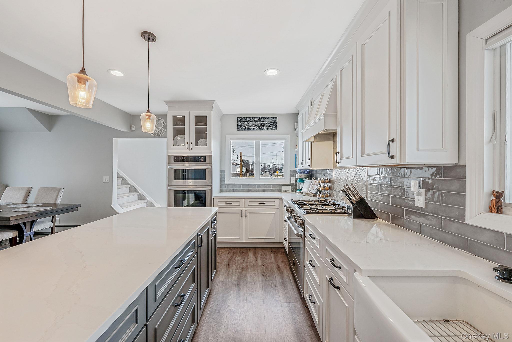 794 Pecan Street Lindenhurst, NY 11757 - Photo 22 of 44 a kitchen with a sink stove and cabinets
