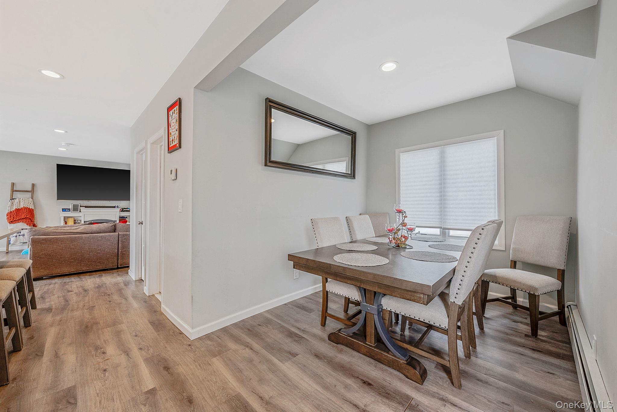 794 Pecan Street Lindenhurst, NY 11757 - Photo 25 of 44 a view of a dining room with furniture and wooden floor