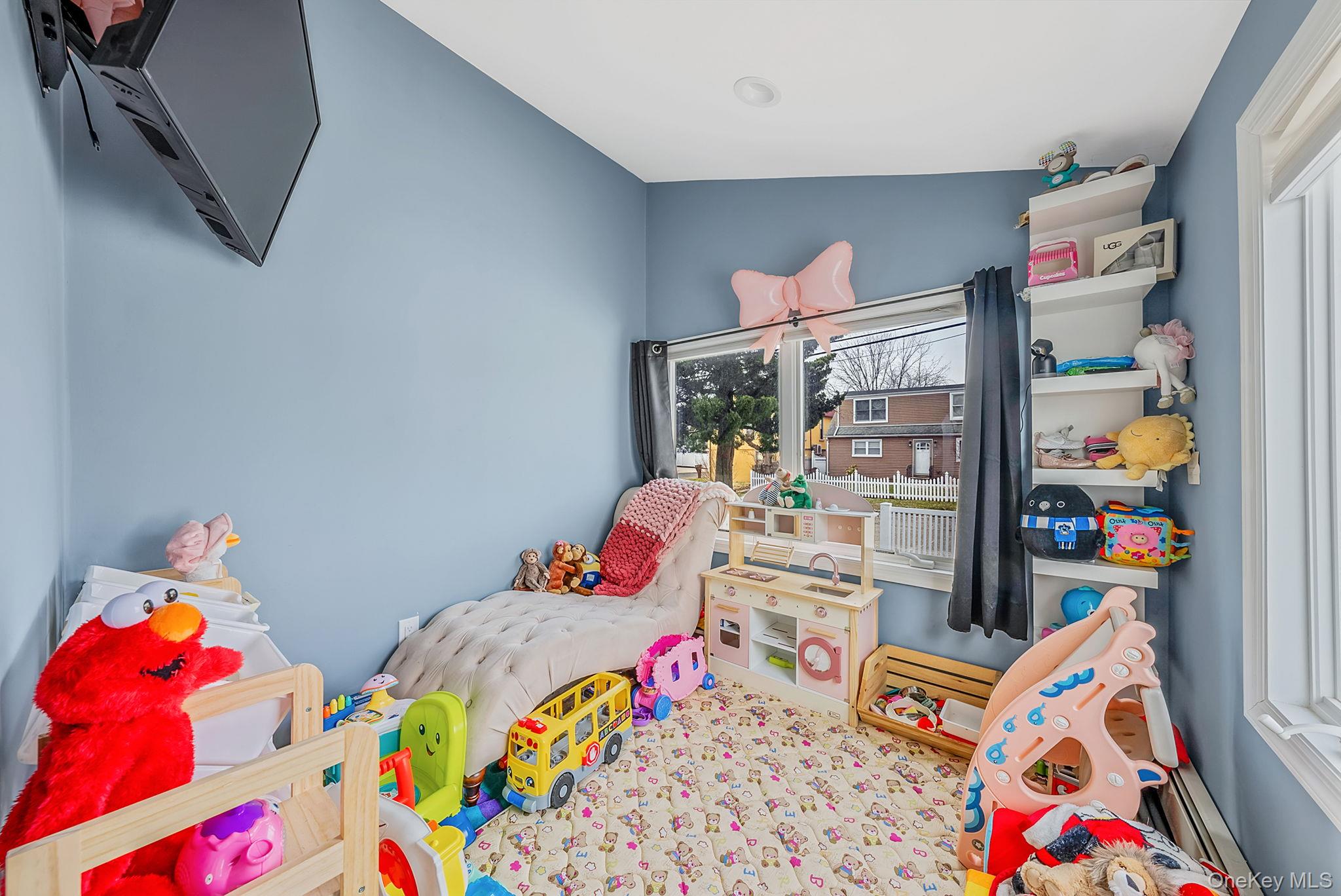 794 Pecan Street Lindenhurst, NY 11757 - Photo 28 of 44 a bed and a bed in a bedroom with baby toys