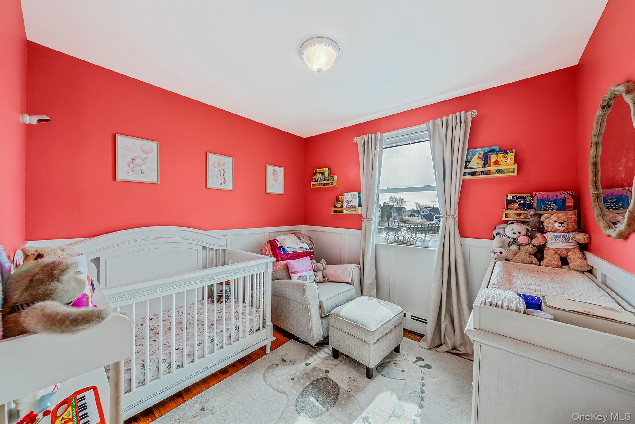 794 Pecan Street Lindenhurst, NY 11757 - Photo 33 of 44 a bedroom with furniture and a baby crib