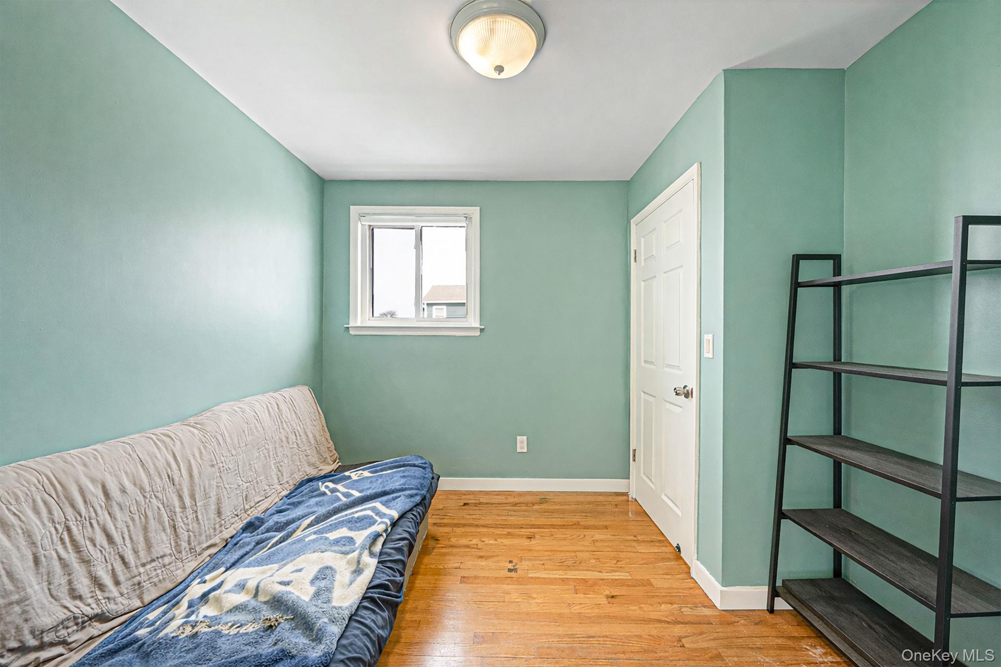 794 Pecan Street Lindenhurst, NY 11757 - Photo 36 of 44 a bedroom with bed and a window