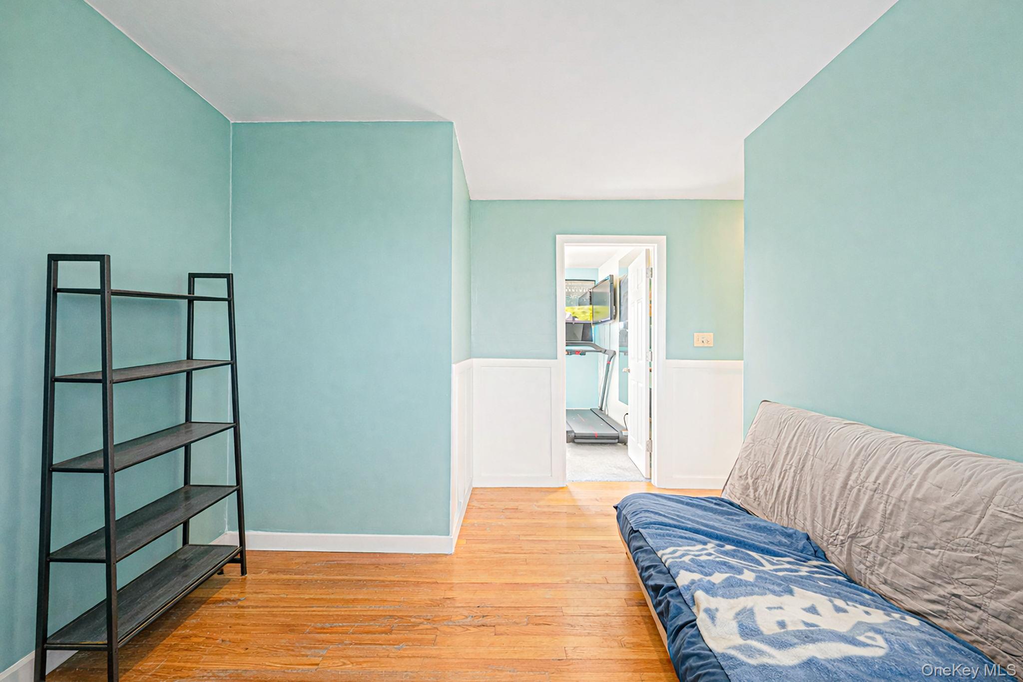 794 Pecan Street Lindenhurst, NY 11757 - Photo 37 of 44 a bedroom with a bed and wooden floor