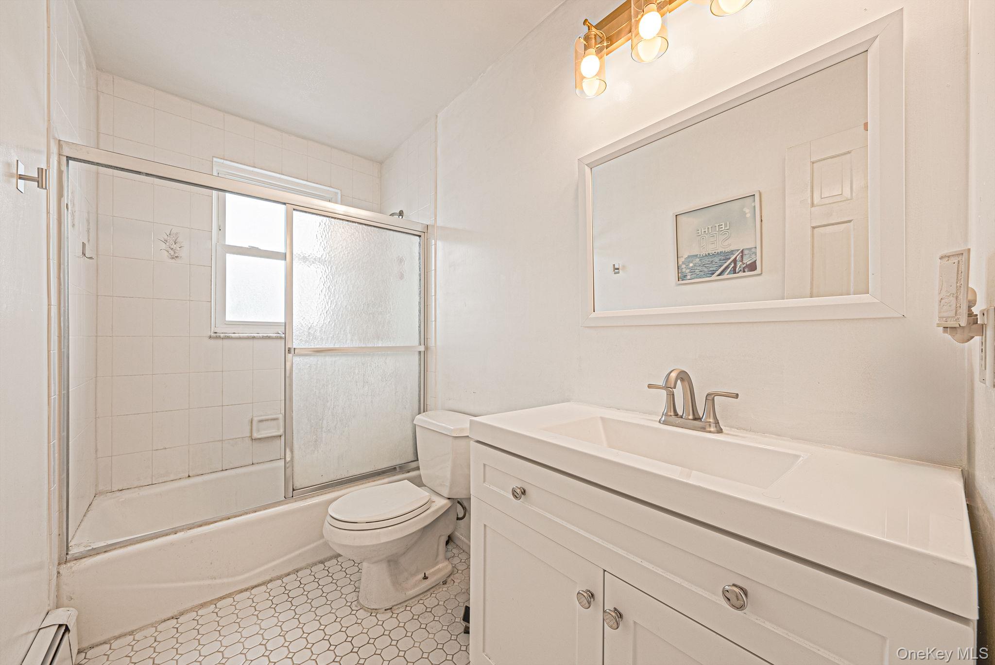 794 Pecan Street Lindenhurst, NY 11757 - Photo 38 of 44 a bathroom with a sink a toilet and shower