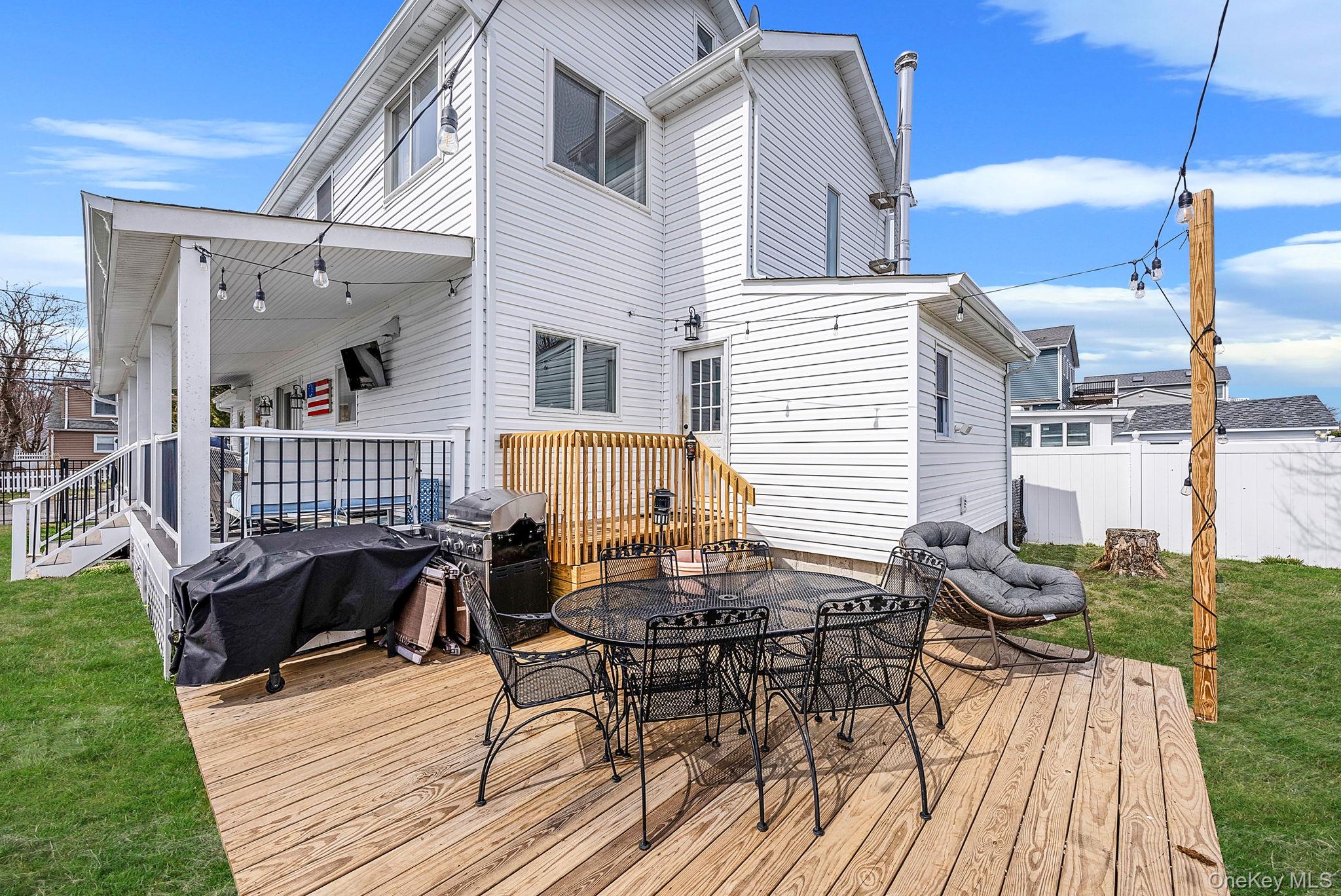 794 Pecan Street Lindenhurst, NY 11757 - Photo 10 of 44 a view of a roof deck with table and chairs couches with wooden floor