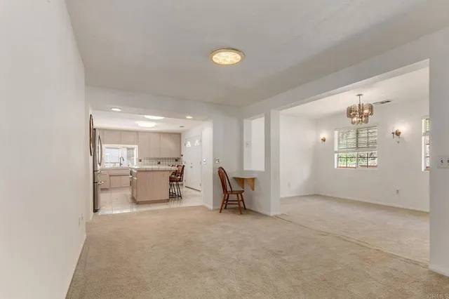 a kitchen with white cabinets and sink