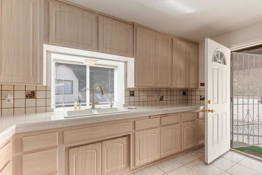 2573 Los Alisos South Fallbrook, CA 92028 - Photo 16 of 70 a kitchen with white cabinets and sink