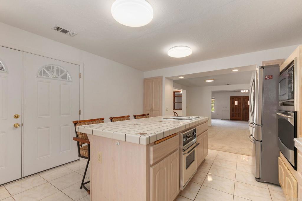 2573 Los Alisos South Fallbrook, CA 92028 - Photo 17 of 70 a kitchen that has a sink and a stove in it
