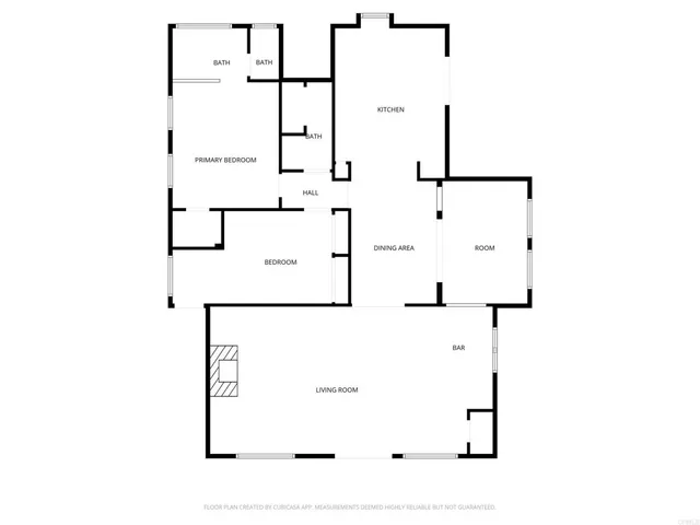a view of a white house with a yard plants and large tree