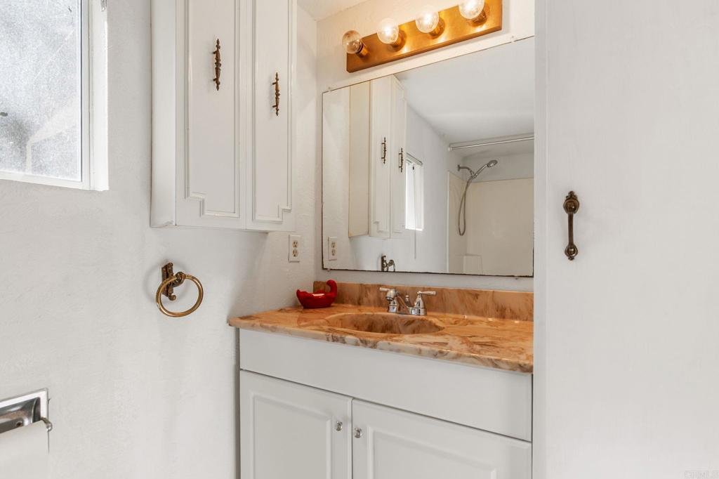2573 Los Alisos South Fallbrook, CA 92028 - Photo 35 of 70 a bathroom with a granite countertop sink and a mirror