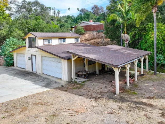 a view of a backyard with a sitting area