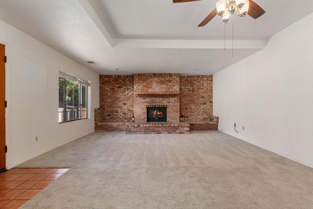 2573 Los Alisos South Fallbrook, CA 92028 - Photo 8 of 70 a view of an empty room with a fireplace and a window