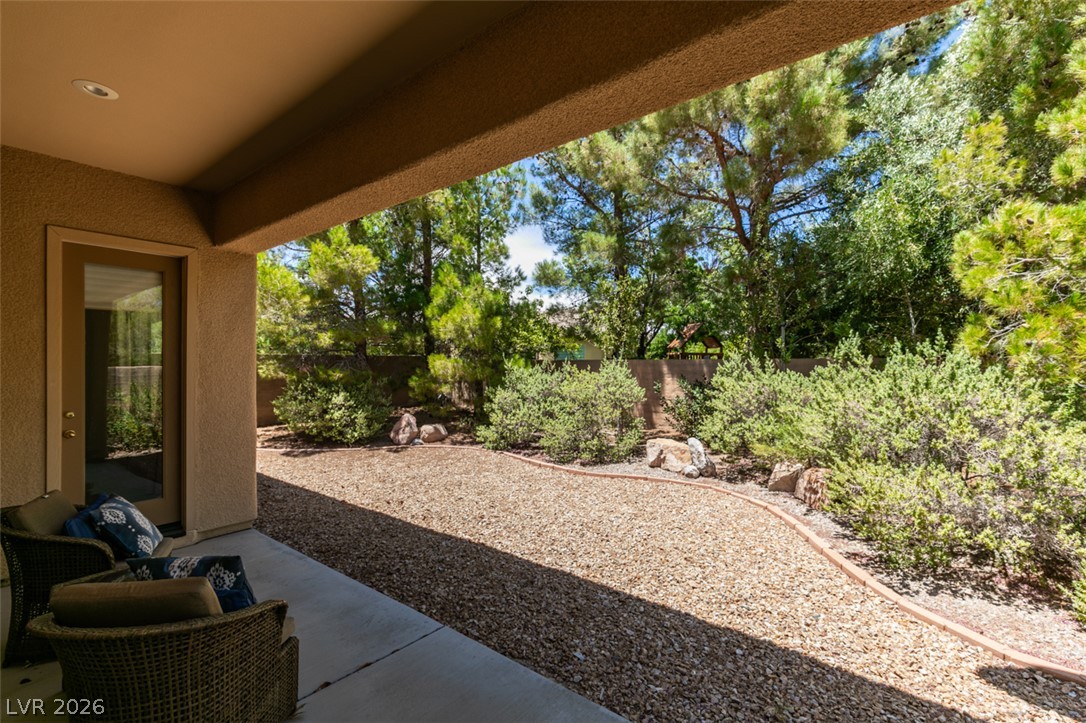8 Kennesaw Road Henderson, NV 89052 - Photo 39 of 44 An inviting covered patio opens to a tranquil yard, perfect for outdoor leisure.