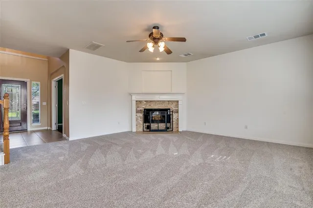 a view of an empty room with a fireplace