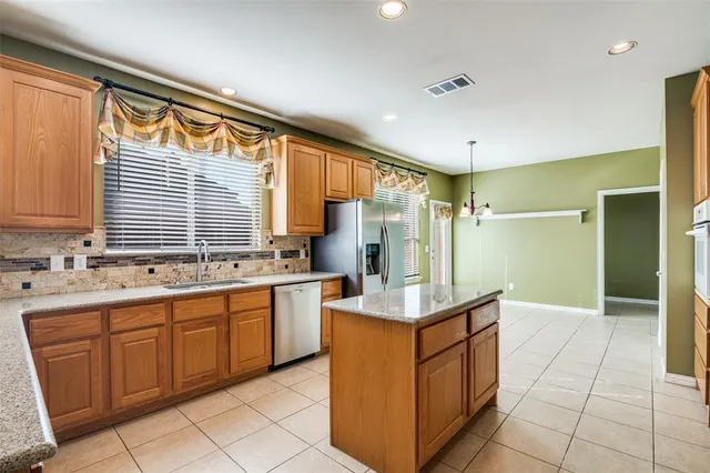 a kitchen with a sink and a refrigerator