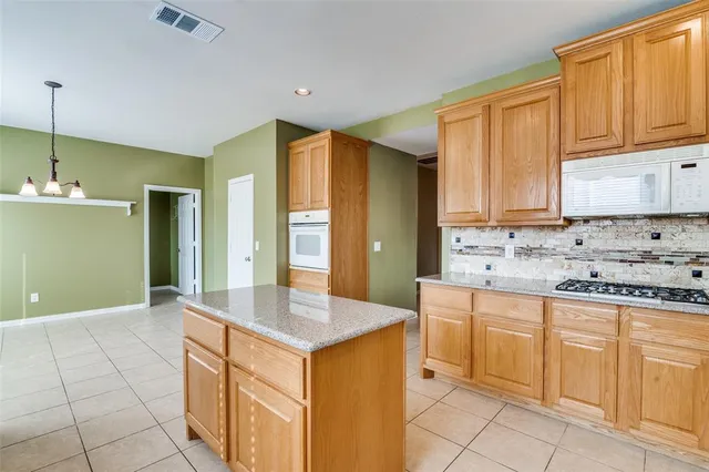 a kitchen with granite countertop a sink and cabinets